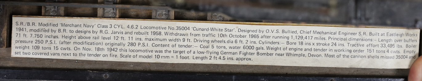 A scratch built scale model ‘S.R./B.R. Modified ‘Merchant Navy’ Class 3 CYL. 4.6.2 Locomotive No.35004 ‘Cunard-White Star’’ and carriage on track. Track length 94.5cm